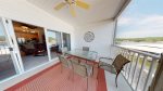 UPPER LEVEL SCREENED IN BALCONY WITH LAKE VIEWS, TABLES AND CHAIRS